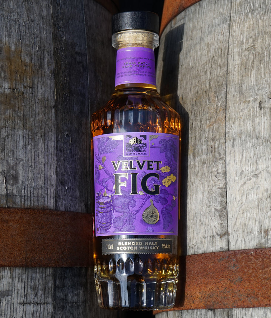 Velvet Fig bottle pictured between two casks